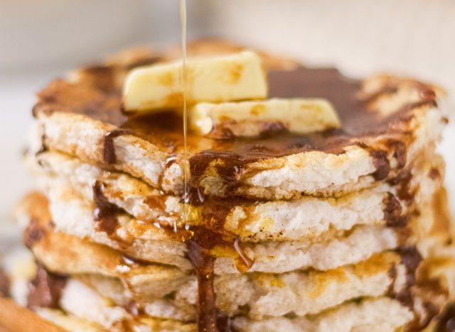 a stack of cinnamon pancakes with syrup and butter