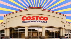A Costco warehouse storefront against a colorful backdrop
