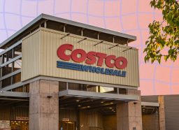 Costco exterior in front of pinkish purple backdrop