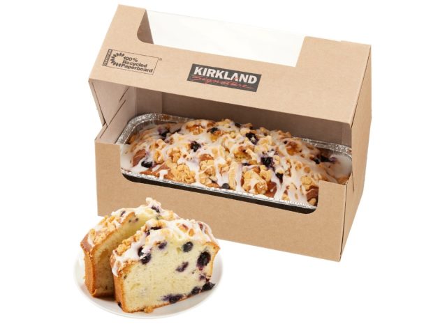 box of costco's lemon blueberry loaf next to a plate with two slices of lemon blueberry loaf