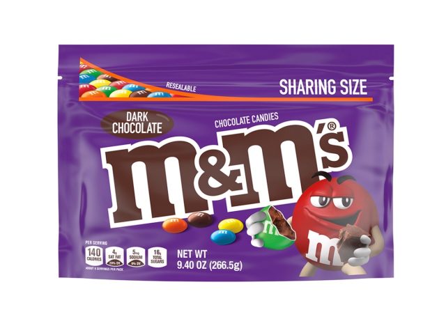 a bag of dark chocolate m & m's on a white background.