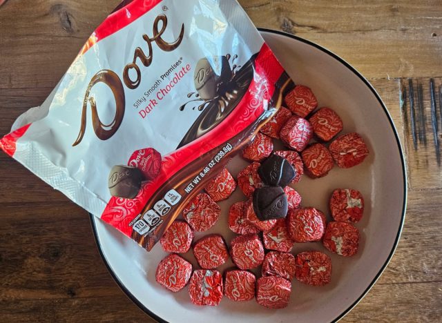 individually wrapped dove chocolates on a white plate with a dove bag.