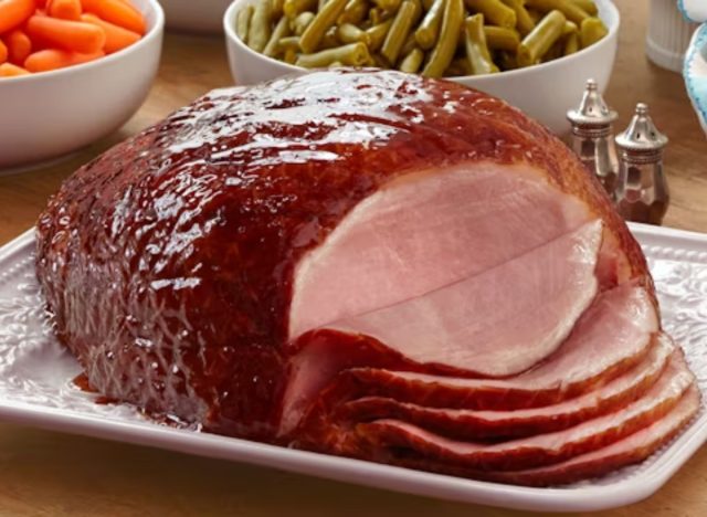 golden corral glazed ham on a plate in front of green beans and carrots