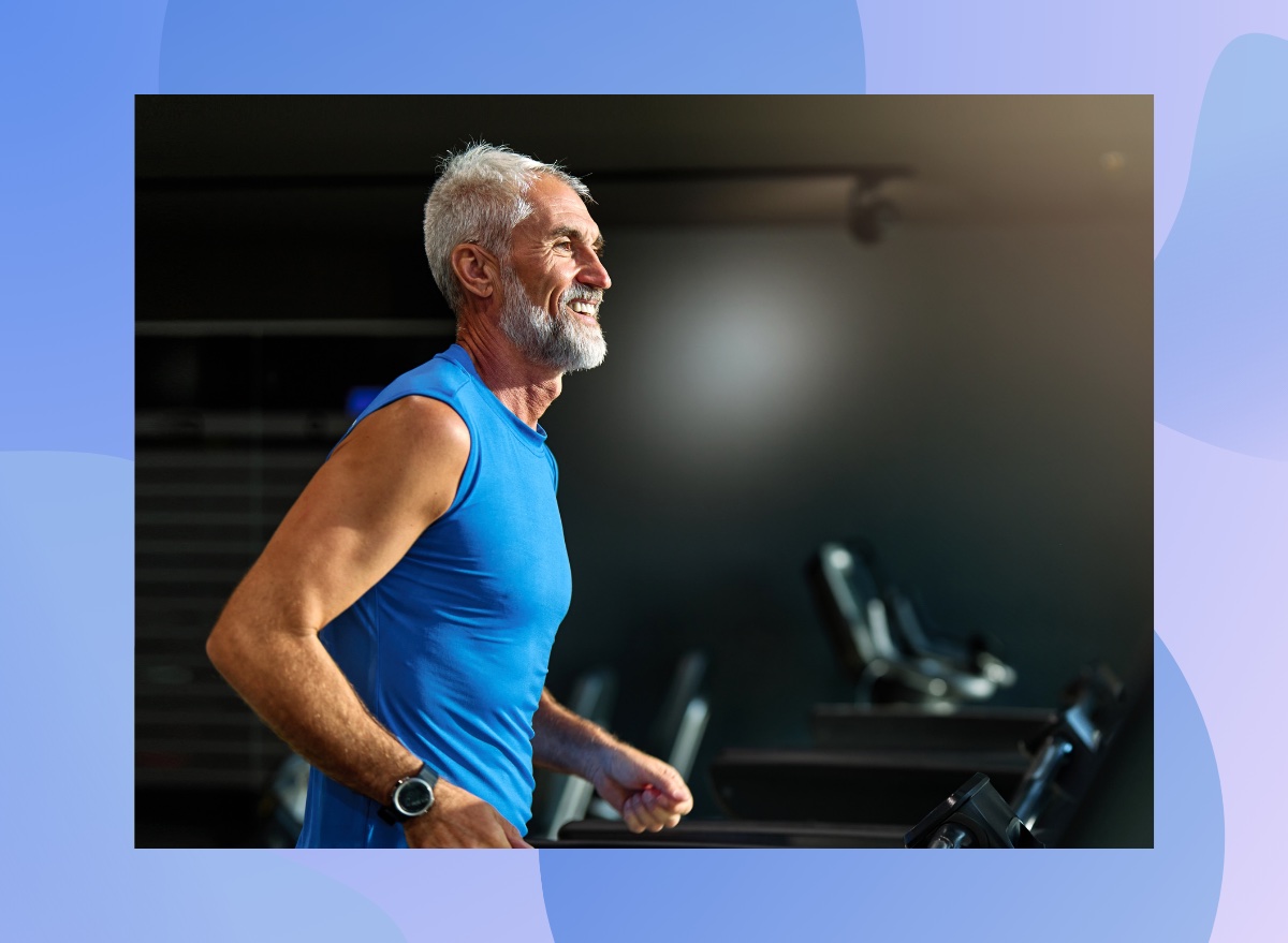 happy mature man walking on a treadmill at the gym