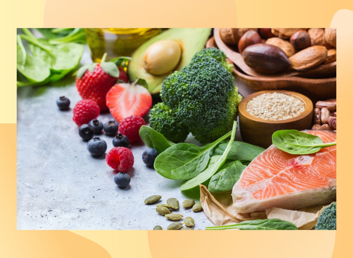 healthy diet concept, broccoli, spinach, berries, nuts, and salmon on countertop