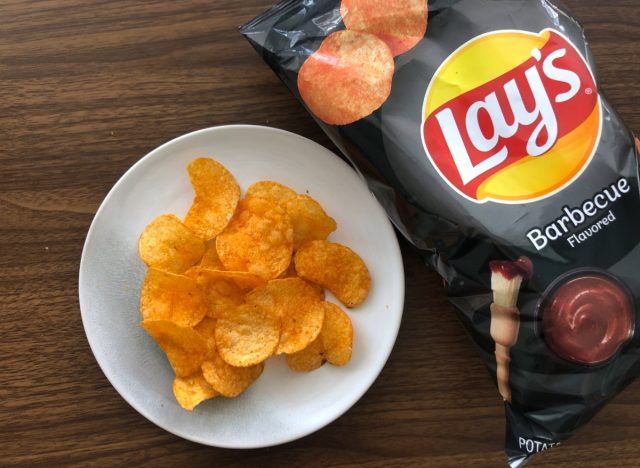 lays bbq potato chips in a bag and on a plate.