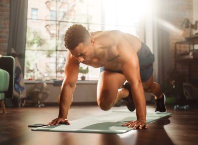 man doing mountain climbers exercise, concept of strength workouts for dad bod