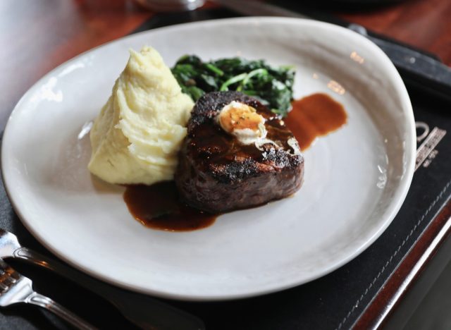 mccormick & shmicks' steak, mashed potatoes, and spinach on white plate