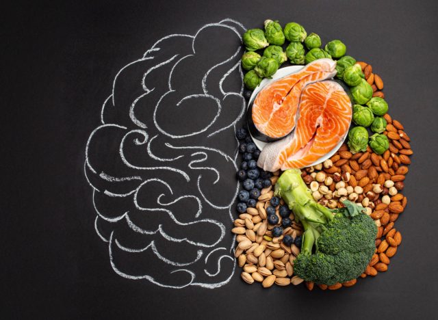 MIND Diet concept, foods like salmon, Brussels sprouts, blueberries, and nuts on drawing of brain