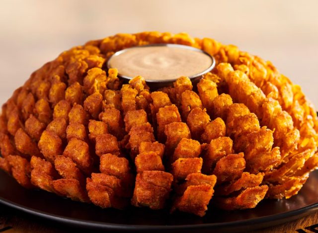 outback steakhouse's bloomin' onion with cup of bloom dipping sauce in the middle