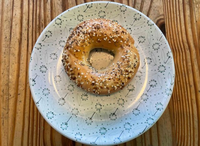 a panera everything bagel on a printed plate.