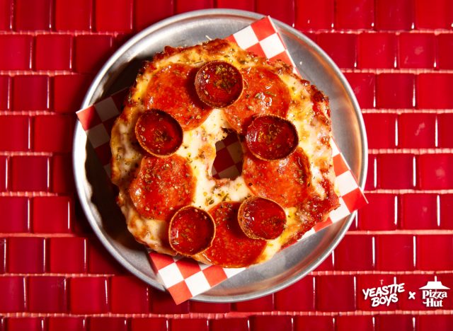 pizza hut's big new yorker pizza bagel on plate against red tiled background