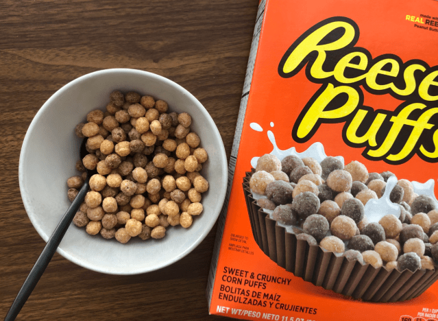 a box and a bowl of reeses puffs cereal.