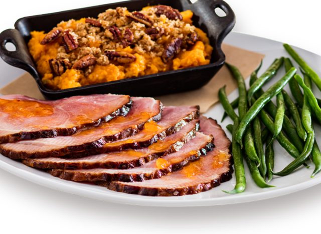 plate with season's 52 apricot-glazed spiral ham, french green beans, and sweet potato mash with maple-pecan streusel