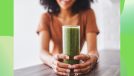 woman holding a glass of smoothie on a green background