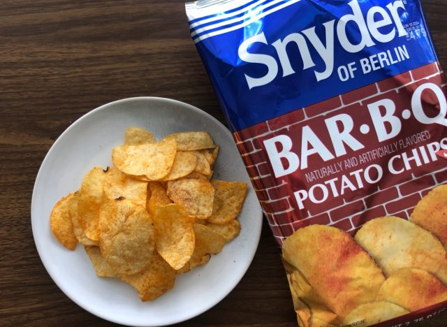 snyder bbq chips on a plate and in a bag.