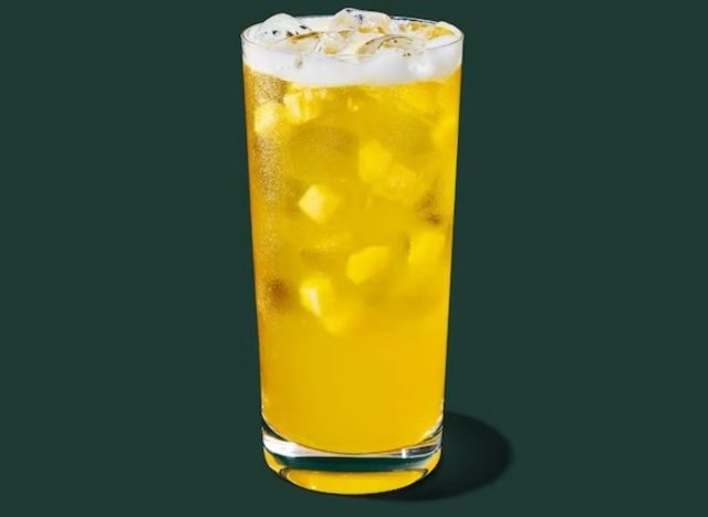 starbucks pineapple passionfruit refresher on a green background.