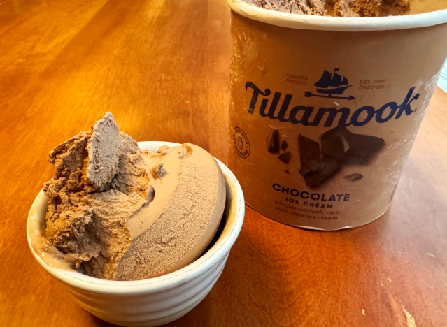 tillamook ice cream container open on a table with a bowl of ice cream.