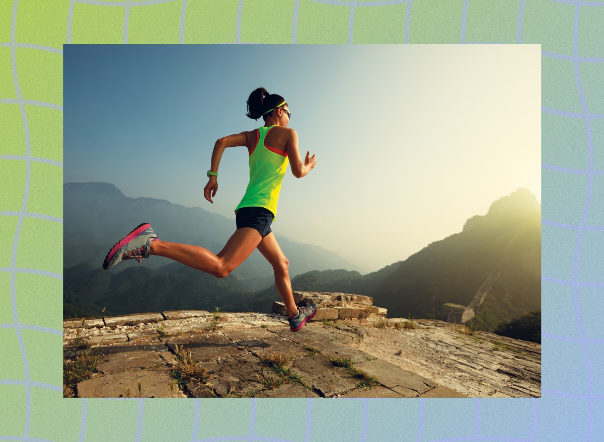 brunette woman in lime green tank doing trail running outdoors by mountains