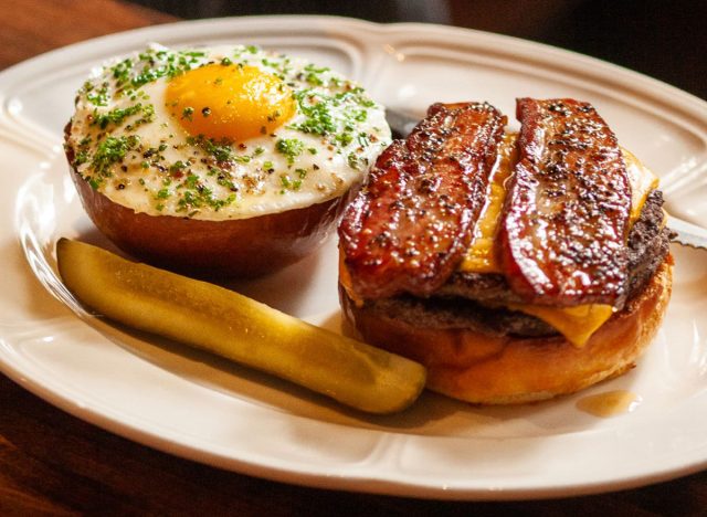 The famous burger at Au Cheval in Chicago, served open faced with a fried egg and pickle