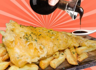 A plate of fish chips and bottle of balsamic vinegar set against a colorful background