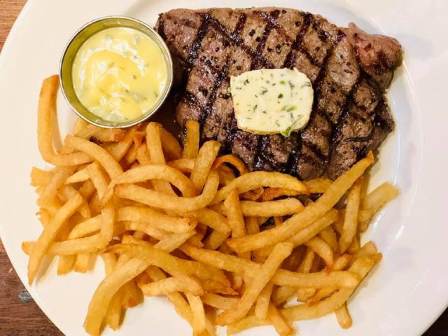 A plate of steak frites at Balthazar restaurant in New York City