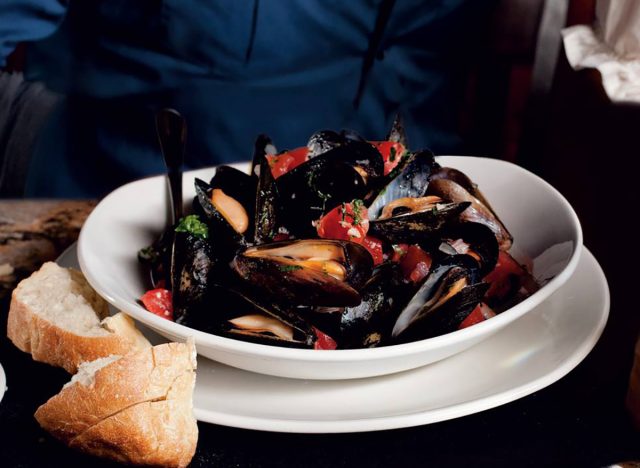 A bowl of steamed mussels with bread from Bonefish Grill
