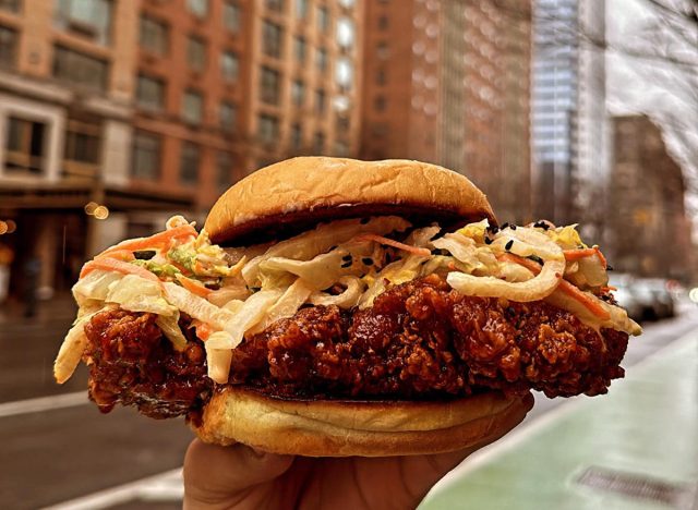 Chick Chick fried chicken sandwich held aloft in New York City