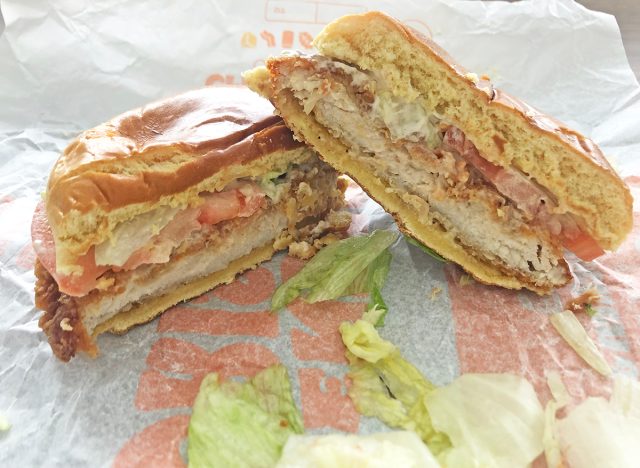 Burger King Classic Royal Crispy Chicken sandwich sliced in half upon its wrapper