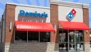 Domino's storefront with striped blue background