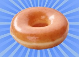 A glossy, glazed doughnut against a colorful background