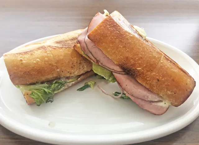 a panera italiano sandwich cut open on a white plate. 