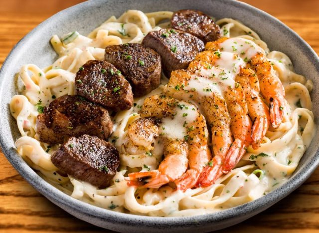 plate of steak and shrimp pasta from Outback Steakhouse