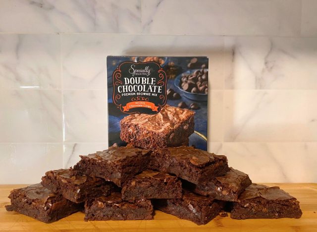 Specially Selected Double Chocolate Premium Brownies and box on a wooden cutting board