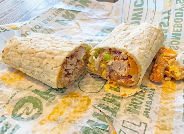 The new Honey Mustard Chicken flatbread wrap from Subway, cut in half upon its wrapper