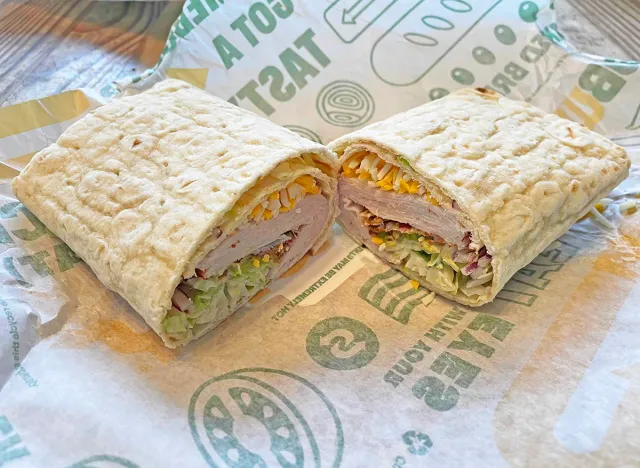 The new Turkey Bacon Avocado flatbread wrap from Subway, cut in half on its wrapper