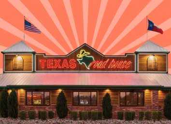 Storefront of a Texas Roadhouse restaurant against a colorful background