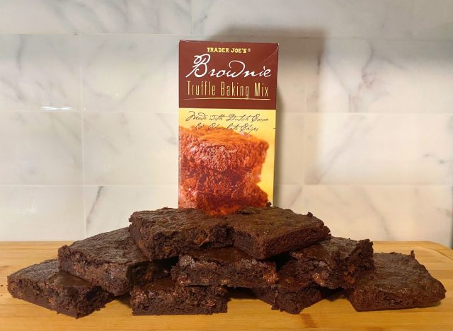 Trader Joe's baking mix brownies and box on a wooden cutting board