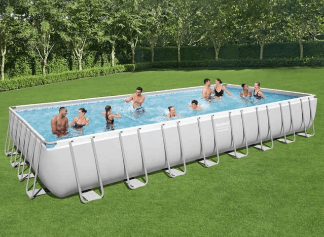 people swimming in a large rectangular pool.