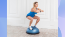 fit blonde woman doing bosu ball squats in bright room