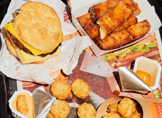 burger king breakfast sandwich, french toast sticks, hash browns, and dipping sauces