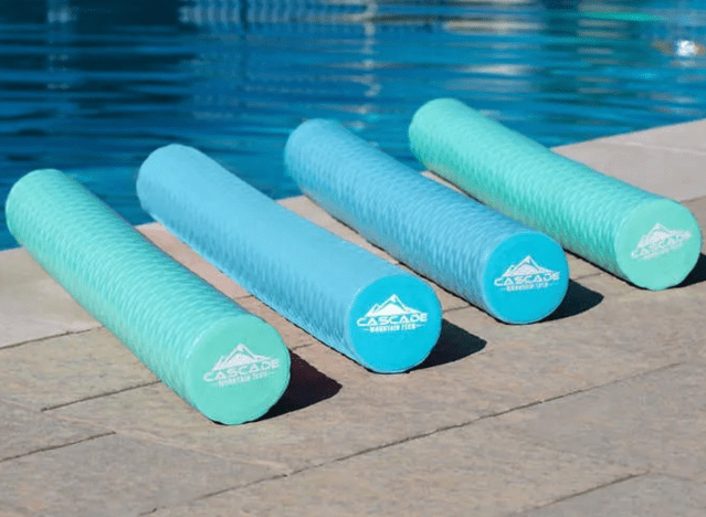 4 pool noodles on a pool deck.