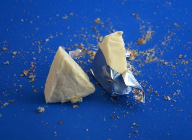 pre-portioned cheese wedges on a blue table