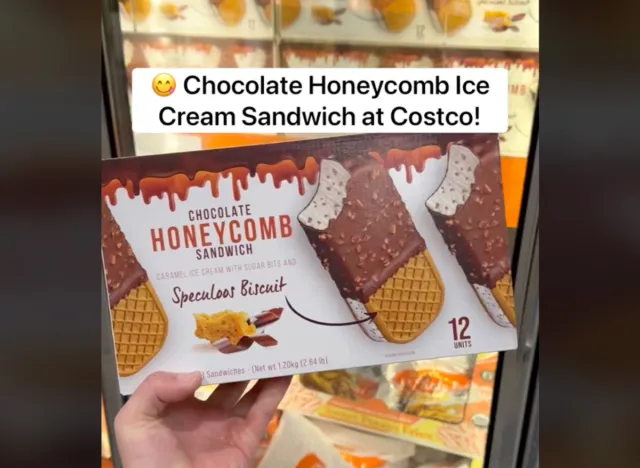 a hand holding a box of chocolate honeycomb ice cream sandwiches