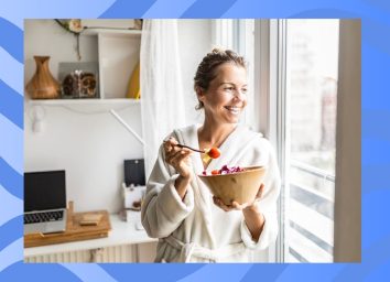 woman eating vegetables in a kitchen