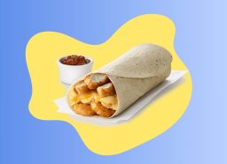 a chick-fil-a breakfast burrito with a dipping sauce on a blue and yellow designed background