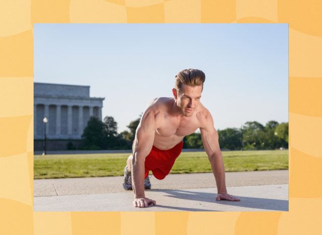 fit, muscular man doing pushups outdoors on cement