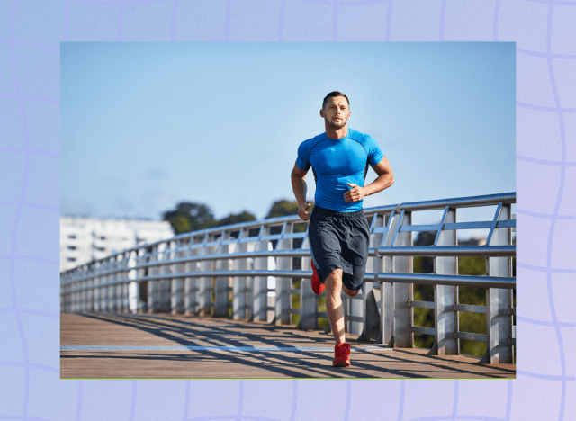 fit man in blue fitted t-shirt and black running shorts running outdoors on boardwalk on sunny day