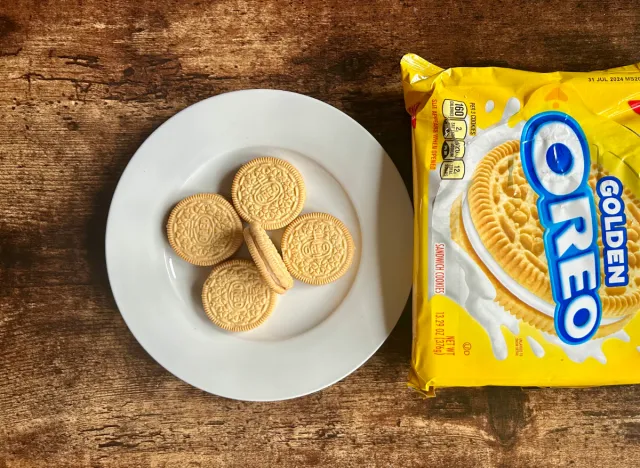 golden oreos on a plate next to package of golden oreos
