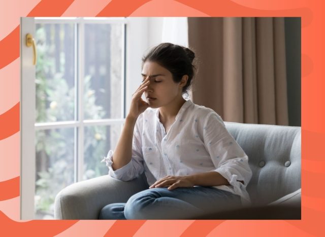 woman sitting on a couch feeling tired